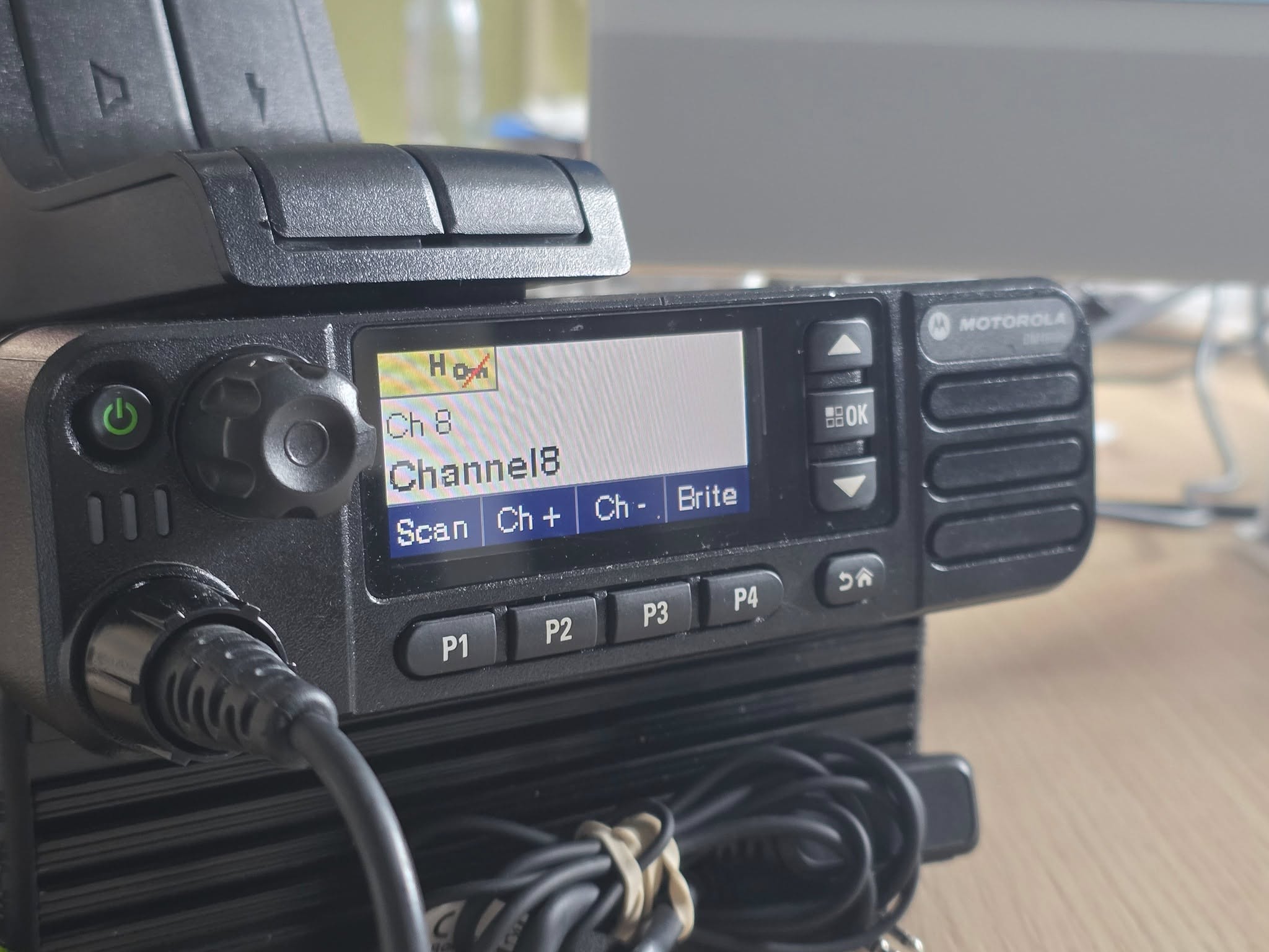 Close-up of a Motorola digital mobile radio powered on and tuned to Channel 8 inside the ERCS event control room.